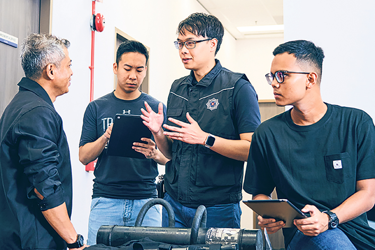 From going on enforcement operations to formulating policies, Ministry of Home Affairs (MHA) Uniformed Scholarship holder Stephen Lim (with tactical vest) hopes to keep Singapore drug-free. PHOTO: SPH MEDIA