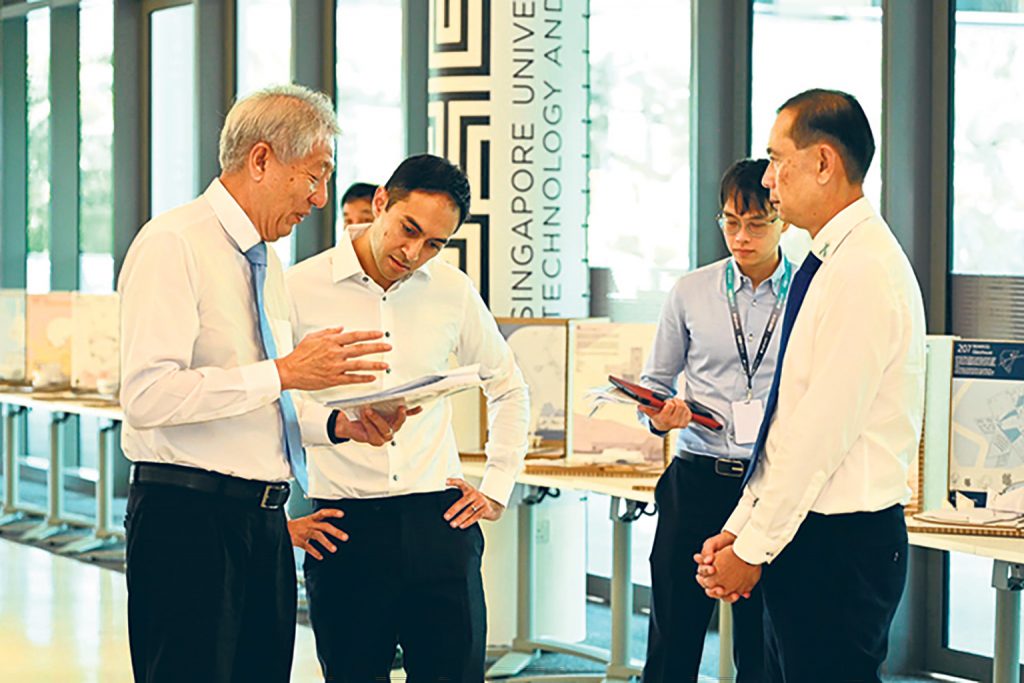 DSP Lim (in blue shirt), who also serves as the Special Assistant to the Director of CNB, was involved in the planning of the agency’s workplan seminar in 2023, which was attended by Senior Minister Teo Chee Hean (far left). PHOTO: STEPHEN LIM