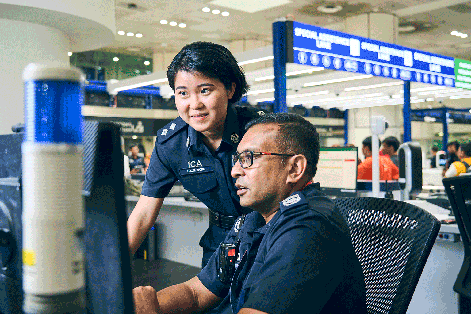 ICA officer Hazel Wong speaking to a fellow officer at the Woodlands Checkpoint