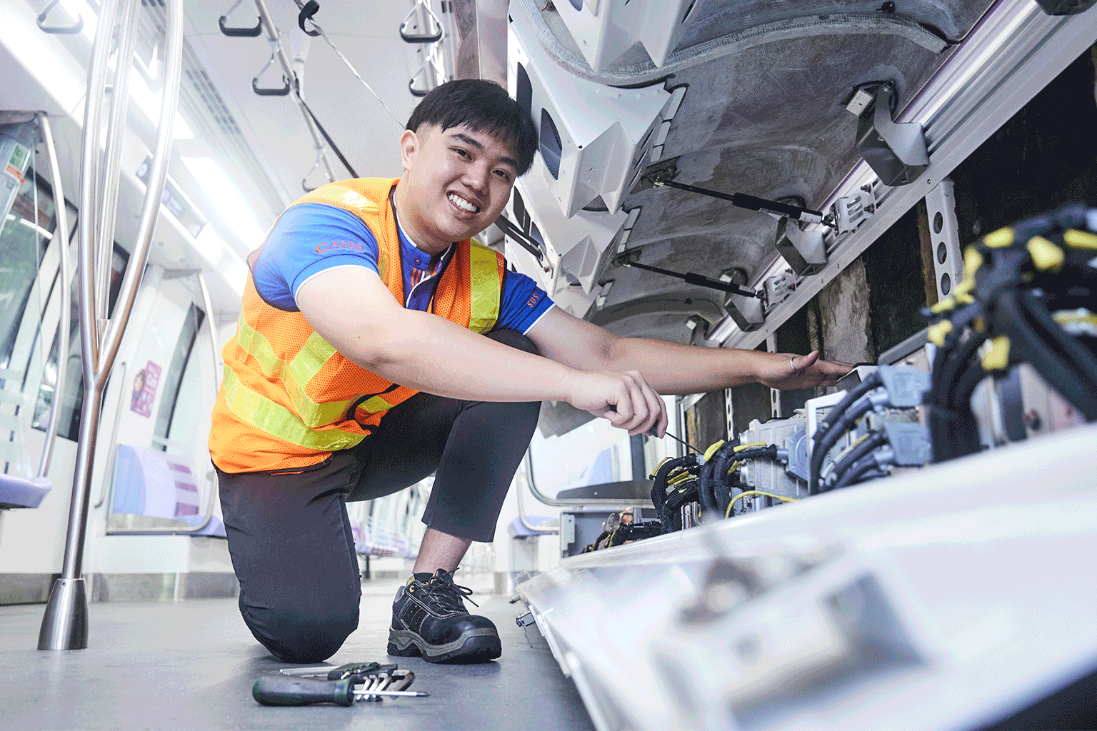 sbst sgrail industry scholar adam wee performing works on NEL train parts singapore