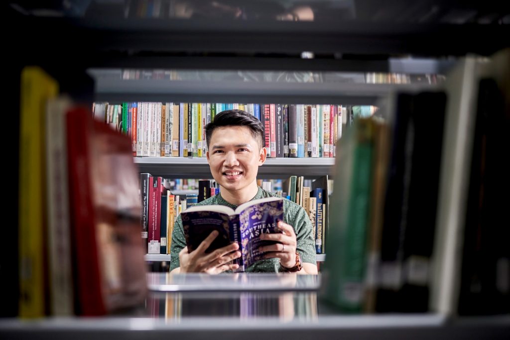 iseas research officer eugene tan at iseas library reading book on south east asia