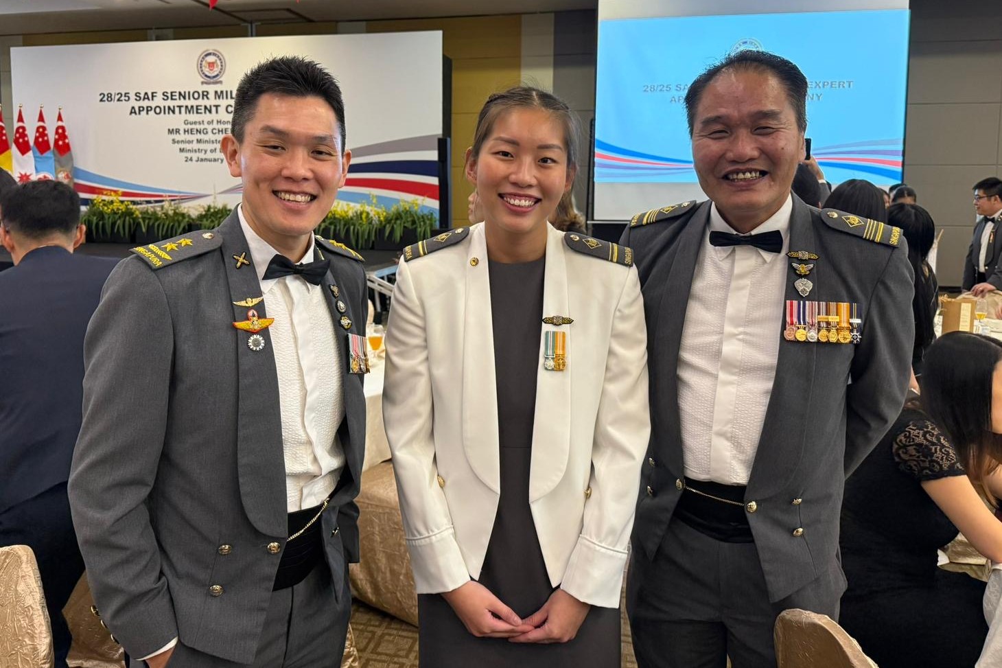 military expert me4 megan wong (centre), pictured with the chief of the digital and intelligence service (dis) (left) and chief expert of dis, after being appointed a senior military intelligence officer in a ceremony in february 2025