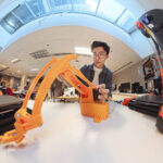Xu Jialu NTU Renaissance Engineering Programme student using a 3-D printer