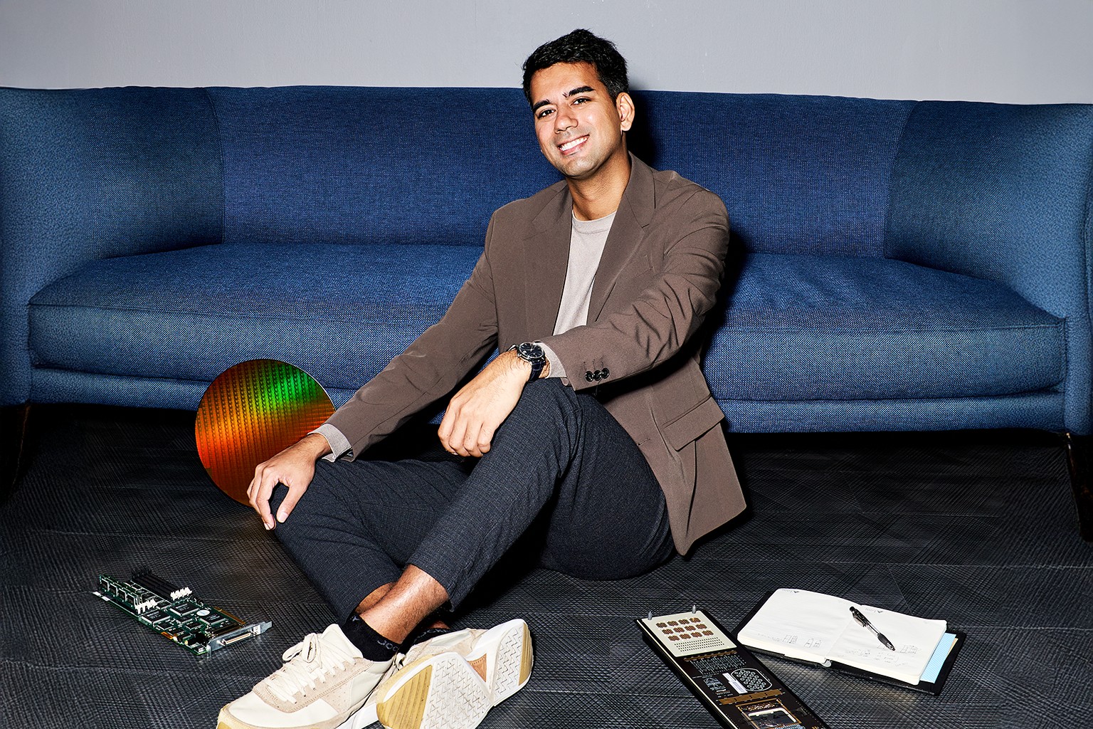 MOE SgIS scholar Nathan Chai sitting on the ground with devices.