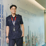 Inspector Weng Qi Hua from ICA standing against a wall
