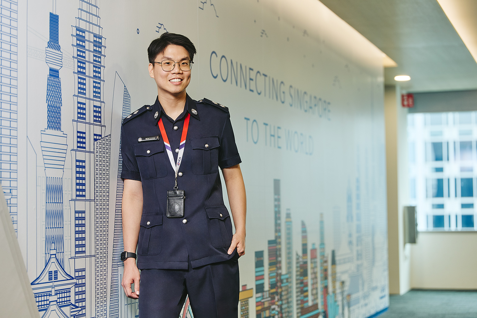 Inspector Weng Qi Hua from ICA standing against a wall