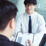 student speaking to interviewers during a scholarship interview