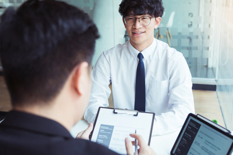 student speaking to interviewers during a scholarship interview