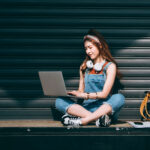 student preparing a scholarship application on a laptop