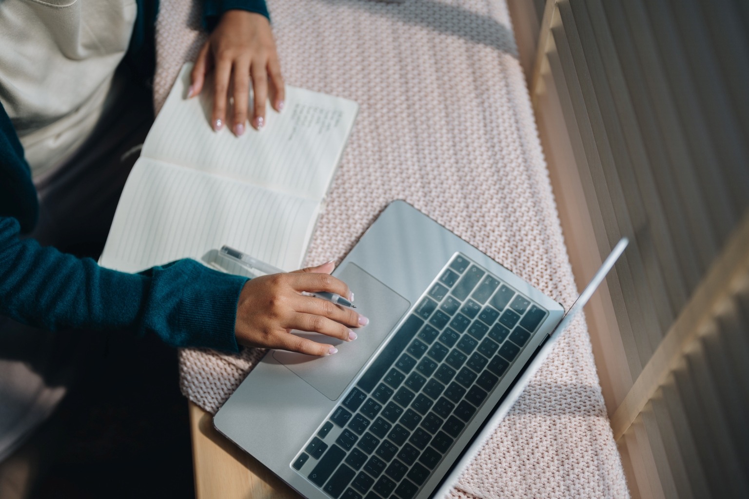 student preparing scholarship essay on laptop