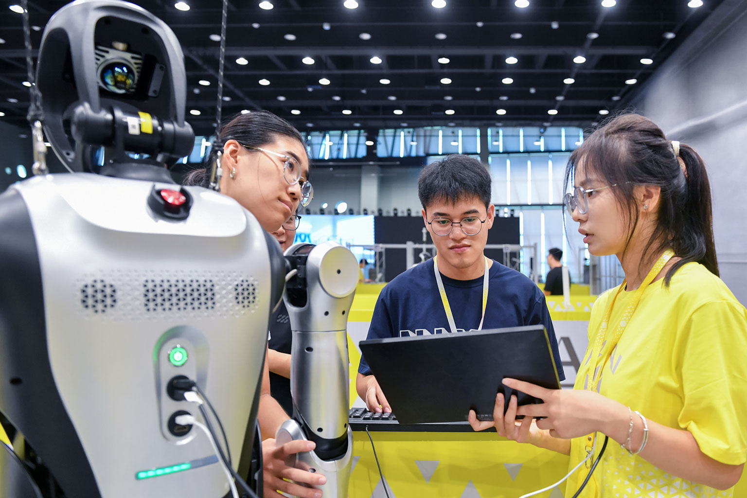 a team of young students discussing how program their robot