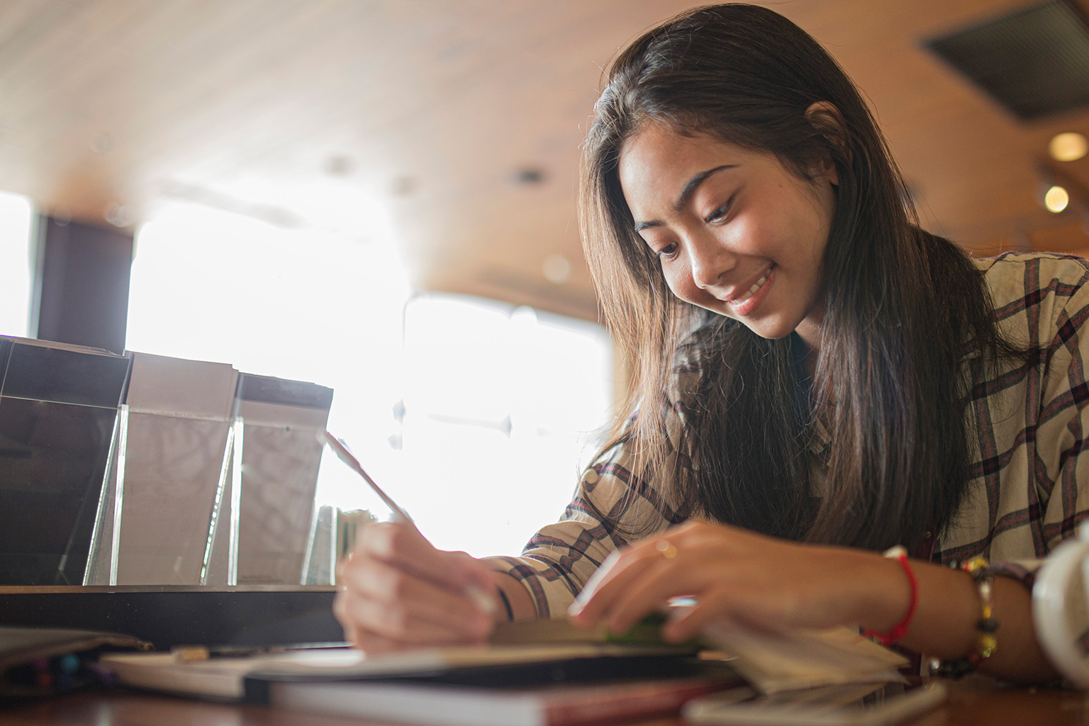 young female student taking notes
